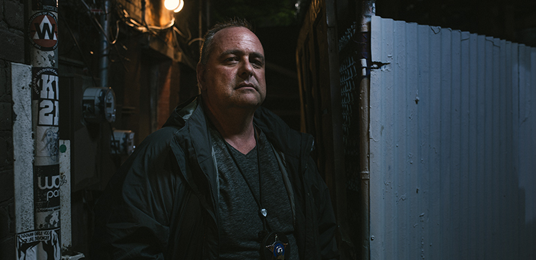 Detective Graham on a Chicago street at night.